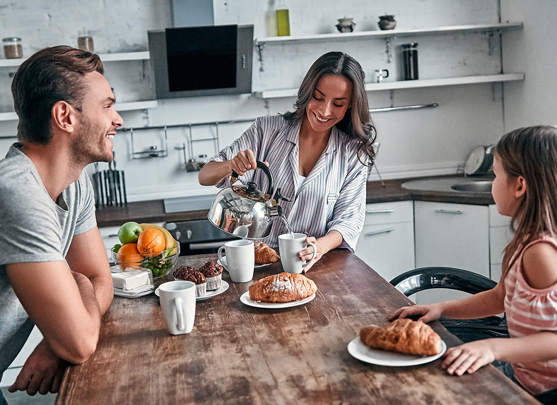 Personal Insurance - Happy Family Sitting Together at Home Having Breakfast